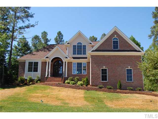 294 High Ridge Lane Pittsboro, NC 27312 - Photo 1 of 11 a front view of a house with a yard and garage