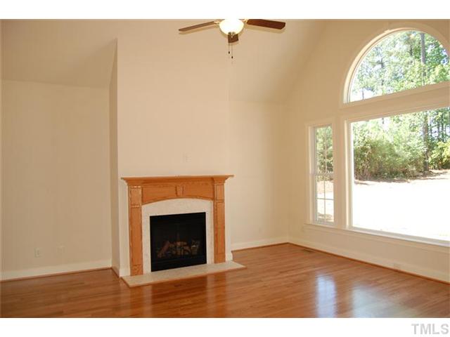 294 High Ridge Lane Pittsboro, NC 27312 - Photo 5 of 11 a view of an empty room with a fireplace and a window