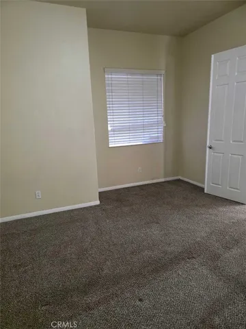an empty room with a empty space and windows