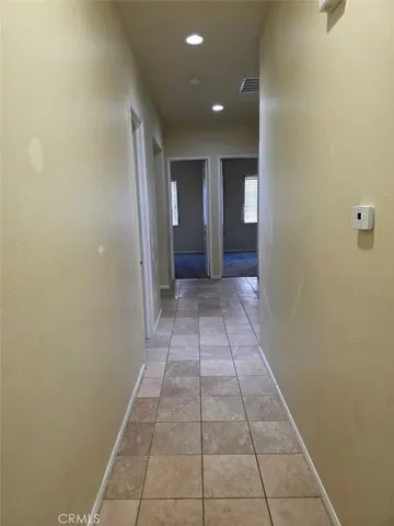 a view of hallway with a window and a mirror