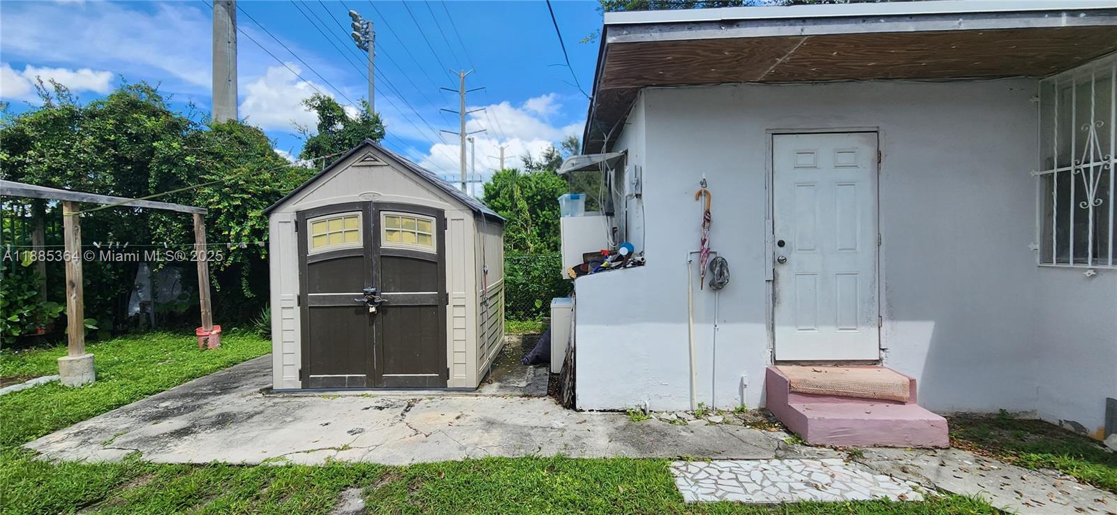 405 Northwest 64th Street Miami, FL 33150 - Photo 13 of 28 a front view of a house with garden