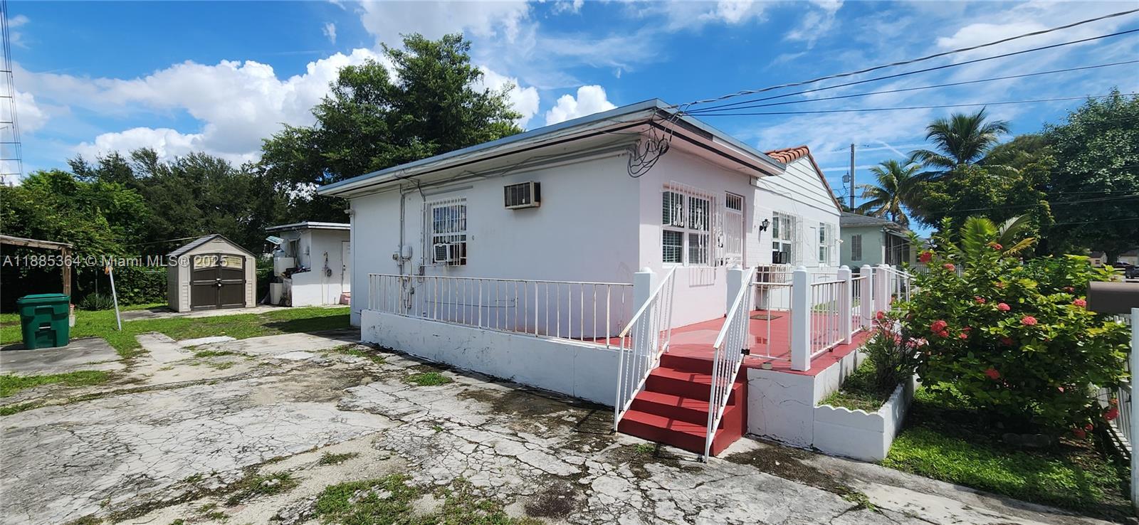405 Northwest 64th Street Miami, FL 33150 - Photo 16 of 28 a view of a house with a yard