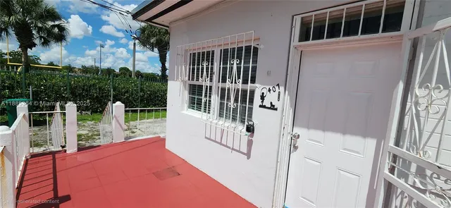 a balcony with table and chairs