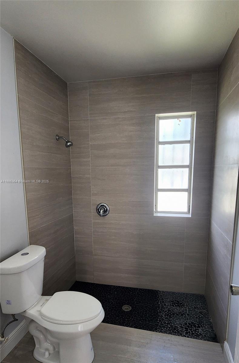 405 Northwest 64th Street Miami, FL 33150 - Photo 28 of 28 a bathroom with a toilet and a shower