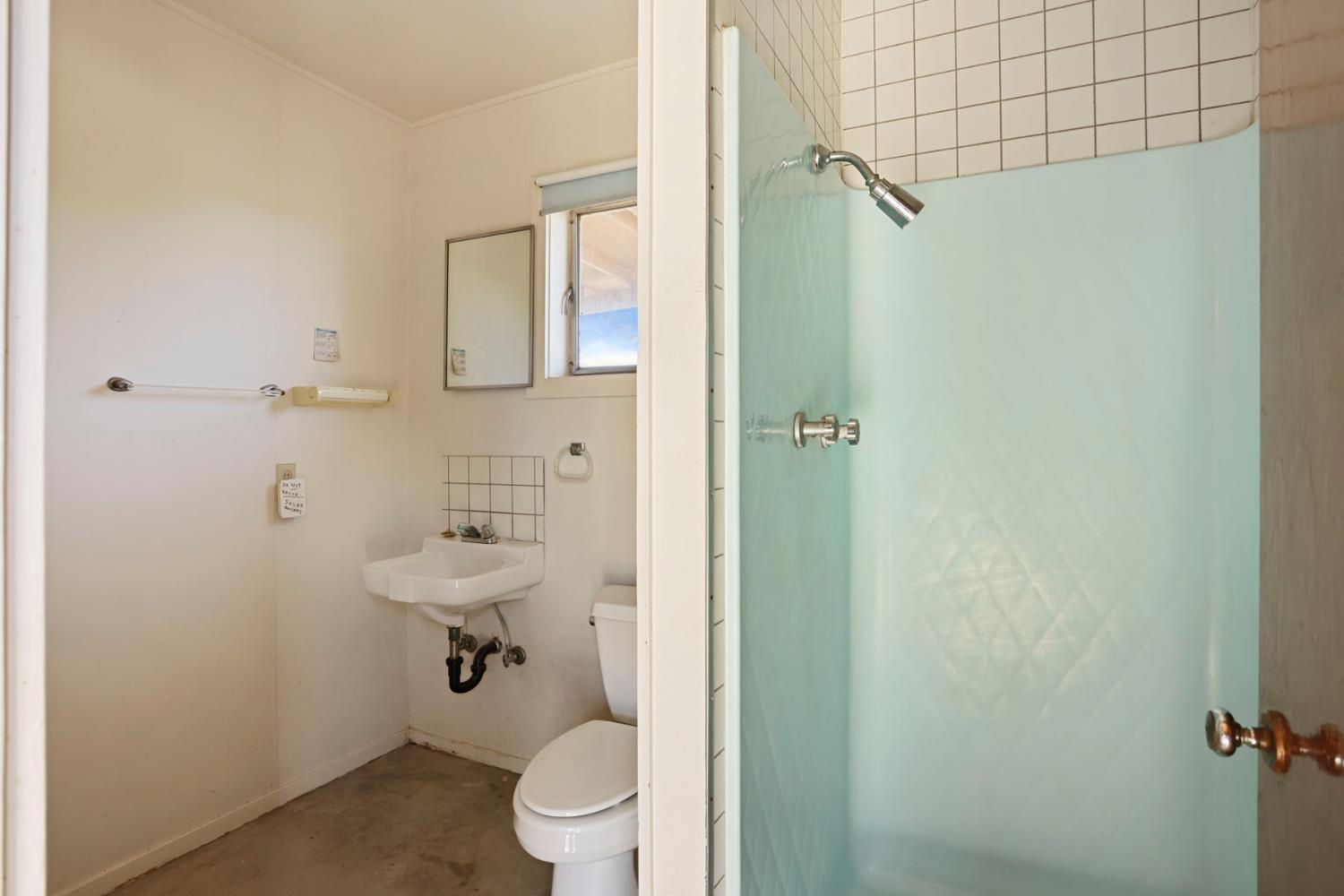 2465 Vernalis Road Tracy, CA 95304 - Photo 42 of 55 a bathroom with a toilet a sink and shower