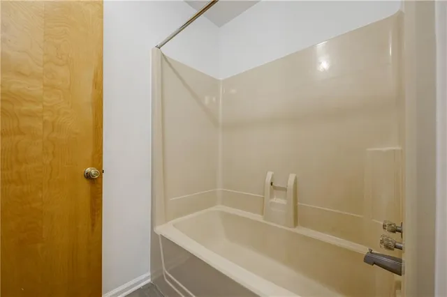 a bathroom with a bathtub and shower