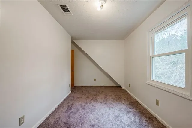 a view of an empty room with windows