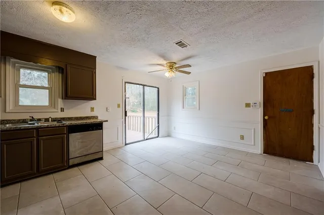 a view of a kitchen with a sink and a refrigerator