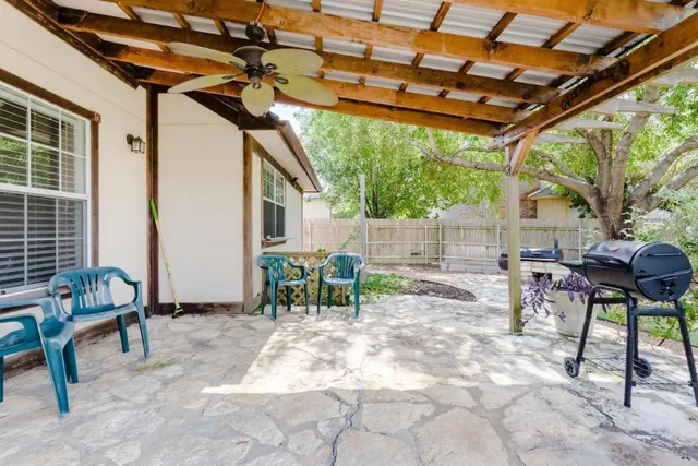 a view of porch with a table and chairs and couches