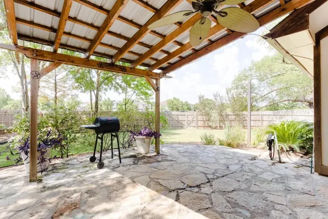 a view of a house with backyard and sitting area