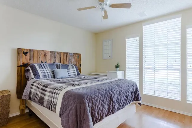 a bedroom with a bed and a chandelier