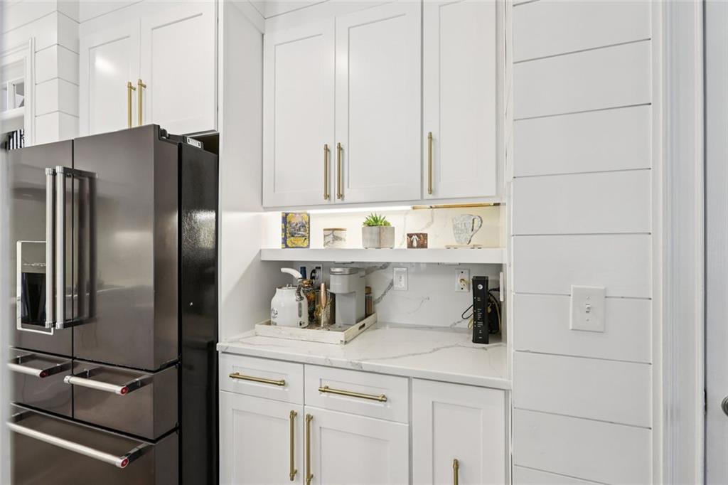 640 Ivy Lea Drive Southeast Lawrenceville, GA 30045 - Photo 19 of 79 a kitchen with stainless steel appliances a refrigerator and cabinets