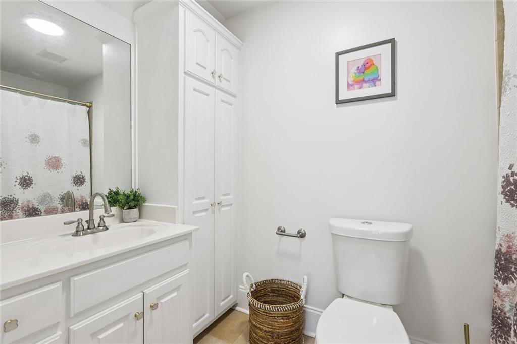 640 Ivy Lea Drive Southeast Lawrenceville, GA 30045 - Photo 37 of 79 a bathroom with a toilet a sink and a mirror