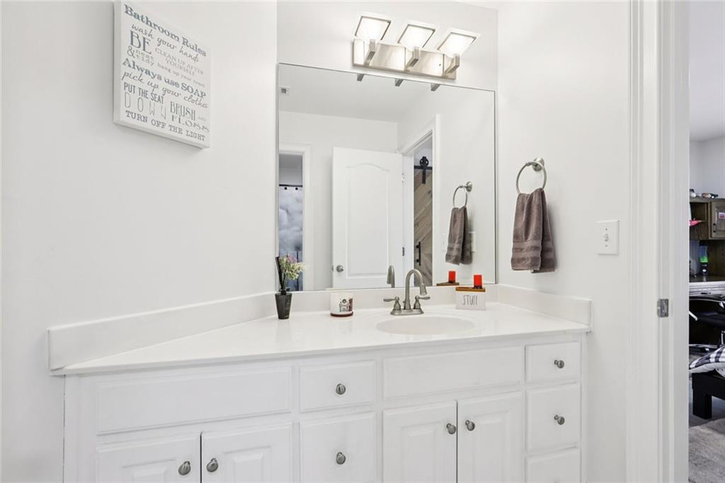 640 Ivy Lea Drive Southeast Lawrenceville, GA 30045 - Photo 41 of 79 a bathroom with a sink vanity and a mirror