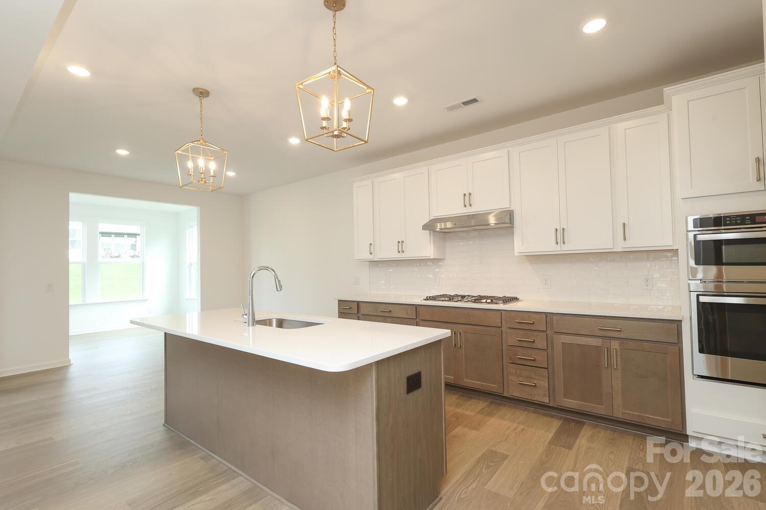 1190 Sugar Crk Road Fort Mill, SC 29707 - Photo 14 of 47 a kitchen with kitchen island granite countertop a sink cabinets and stainless steel appliances
