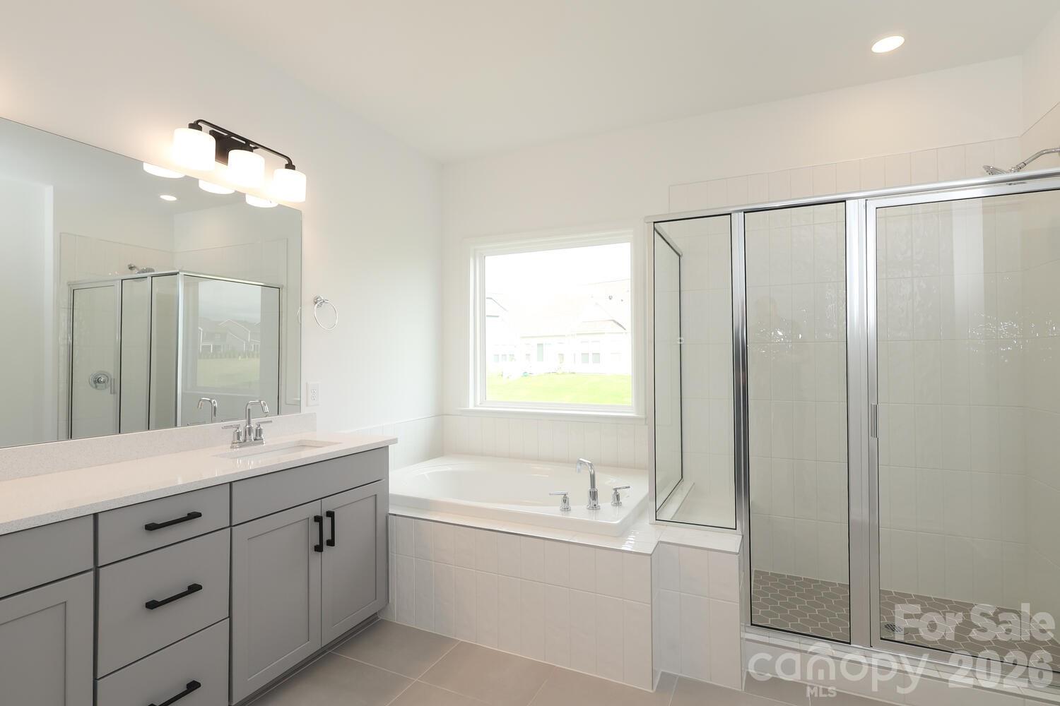 1190 Sugar Crk Road Fort Mill, SC 29707 - Photo 30 of 47 a bathroom with a double vanity sink toilet mirror and bathtub