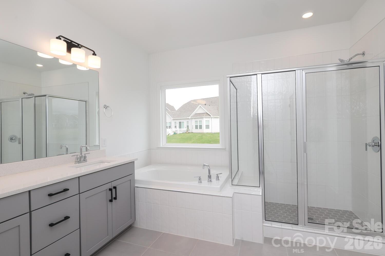 1190 Sugar Crk Road Fort Mill, SC 29707 - Photo 33 of 47 a bathroom with a bathtub a sink and a mirror