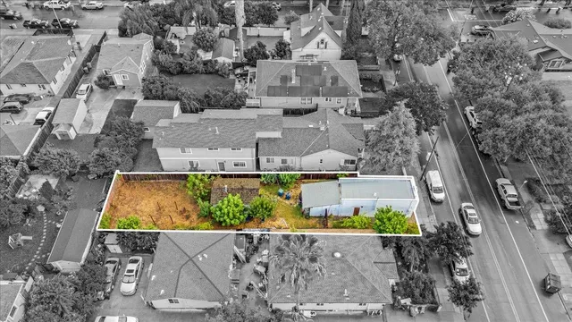 a view of swimming pool with a yard and potted plants