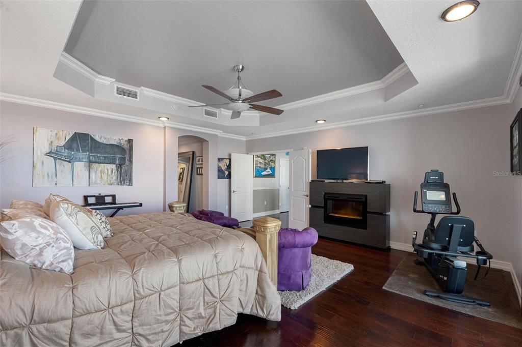 17717 Gulf Boulevard, Unit 702 Redington Shores, FL 33708 - Photo 23 of 99 a spacious bedroom with a bed dresser and a flat screen tv