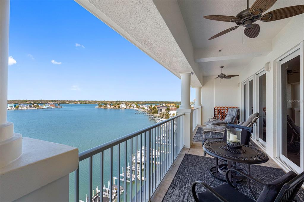 17717 Gulf Boulevard, Unit 702 Redington Shores, FL 33708 - Photo 31 of 99 a view of a chairs and table in a balcony