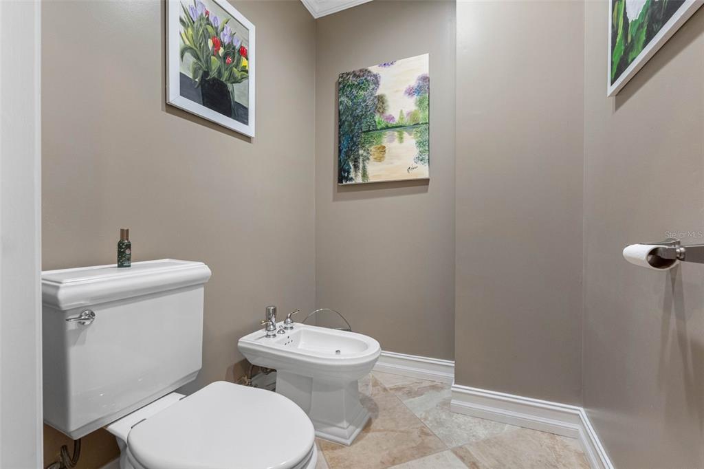 17717 Gulf Boulevard, Unit 702 Redington Shores, FL 33708 - Photo 40 of 99 a white toilet sitting next to a bathroom sink