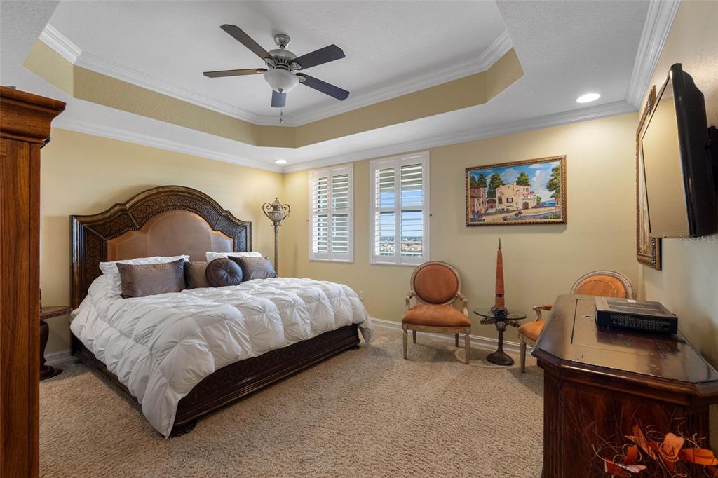 17717 Gulf Boulevard, Unit 702 Redington Shores, FL 33708 - Photo 67 of 99 a bedroom with a bed and a chandelier