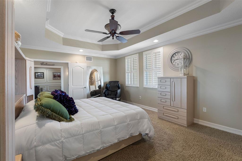 17717 Gulf Boulevard, Unit 702 Redington Shores, FL 33708 - Photo 74 of 99 a bedroom with a bed and a chandelier