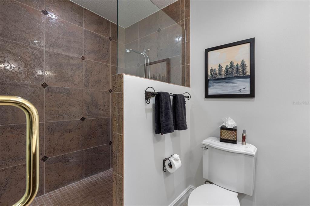 17717 Gulf Boulevard, Unit 702 Redington Shores, FL 33708 - Photo 77 of 99 a bathroom with a toilet and a shower