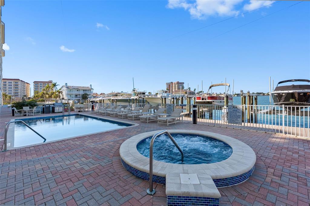 17717 Gulf Boulevard, Unit 702 Redington Shores, FL 33708 - Photo 91 of 99 a view of a swimming pool with a lounge chair