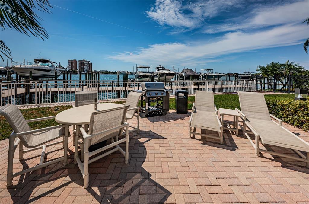 17717 Gulf Boulevard, Unit 702 Redington Shores, FL 33708 - Photo 94 of 99 a view of a chairs and table on the terrace