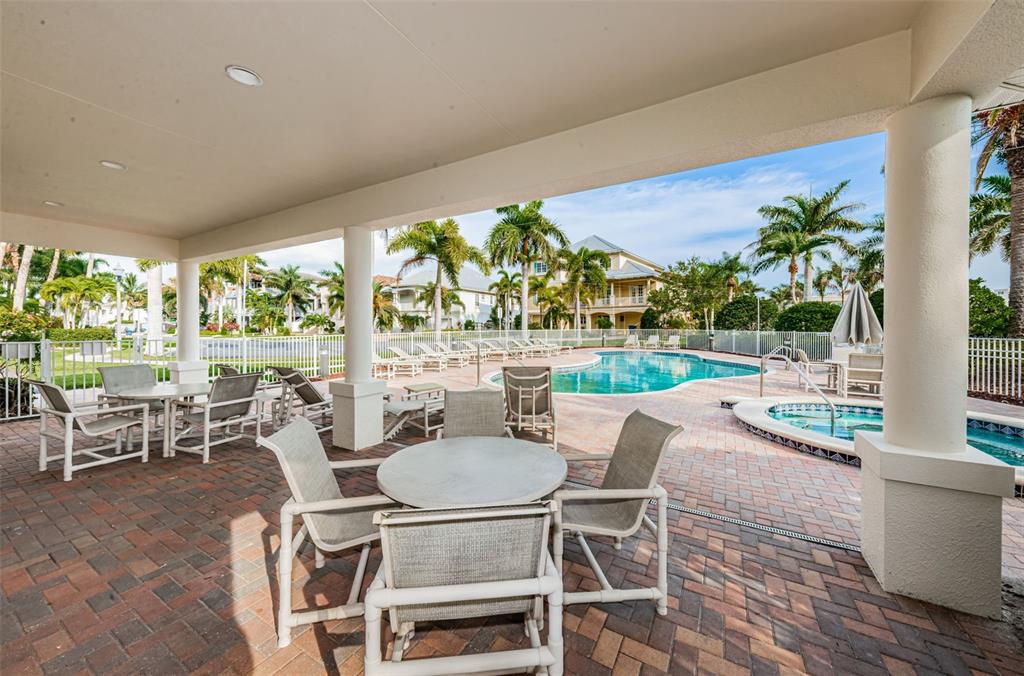 17717 Gulf Boulevard, Unit 702 Redington Shores, FL 33708 - Photo 96 of 99 a dining room with furniture and a floor to ceiling window