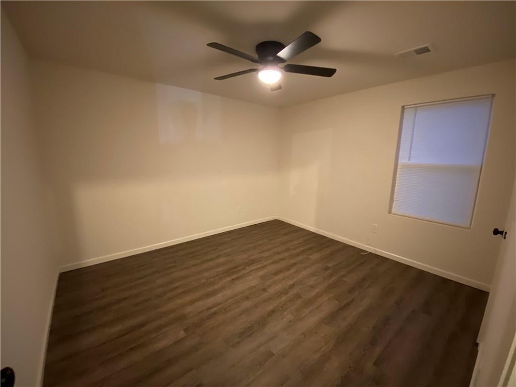 764 Dove Tree Lane Social Circle, GA 30025 - Photo 15 of 32 an empty room with wooden floor and windows