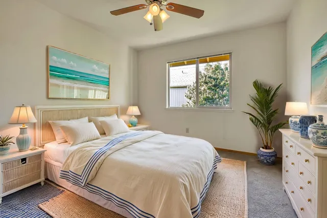 a bedroom with bed and a potted plant