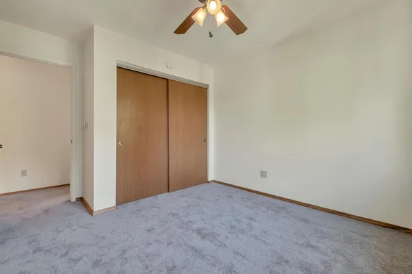 an empty room with a ceiling fan