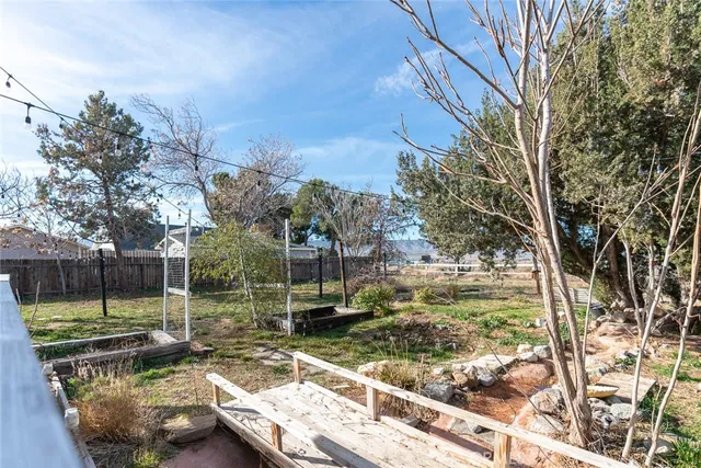 a view of a backyard with wooden floor and a fire pit