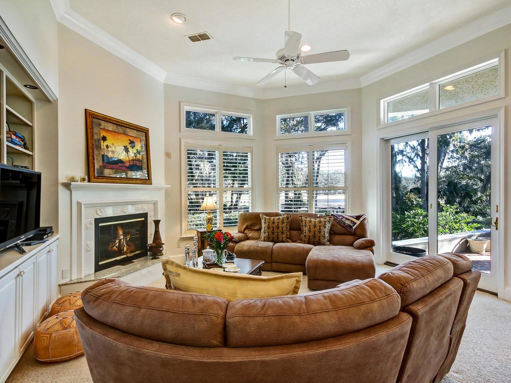 35 Sea Marsh Road Amelia Island, FL 32034 - Photo 6 of 34 a living room with furniture a large window and a fireplace