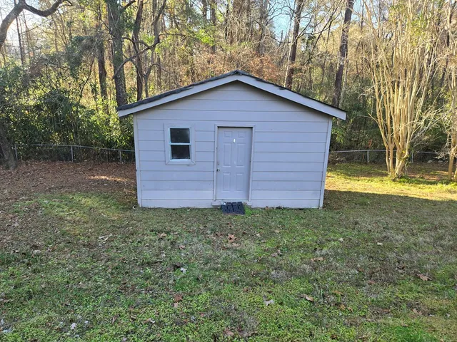 a view of a backyard with large trees
