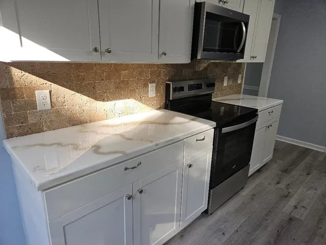 a kitchen with a sink and steel appliances