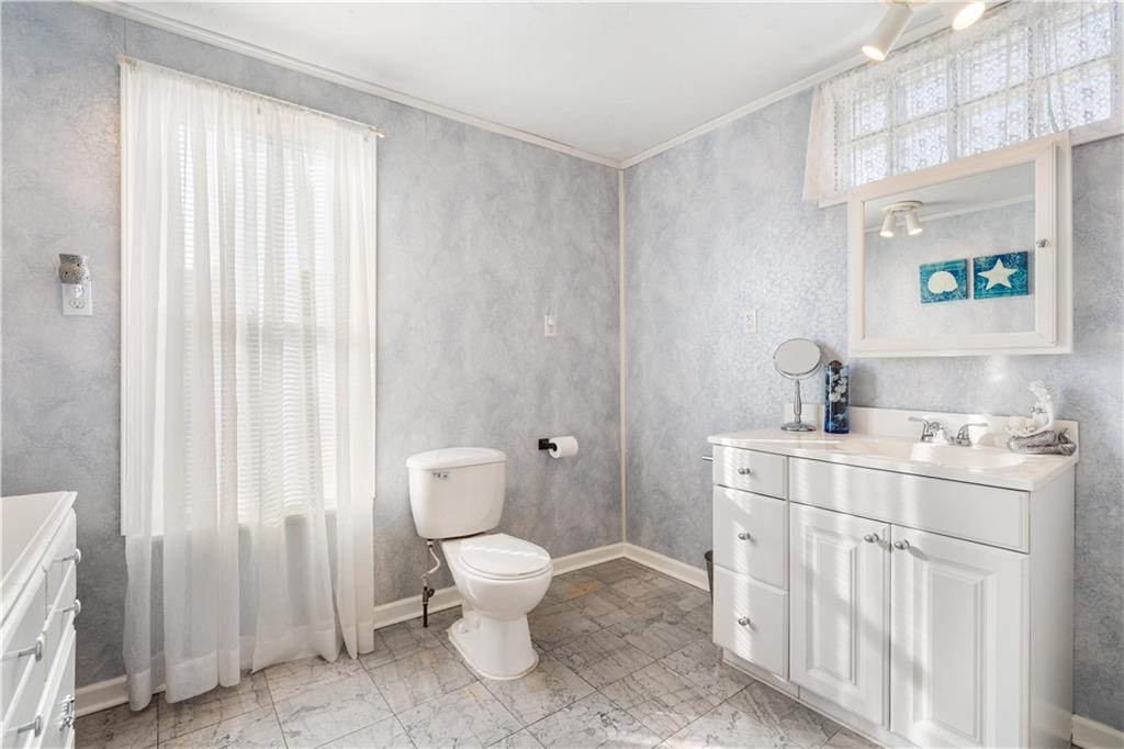 183 Clay Street Rochester, PA 15074 - Photo 22 of 25 a spacious bathroom with a toilet sink and a mirror