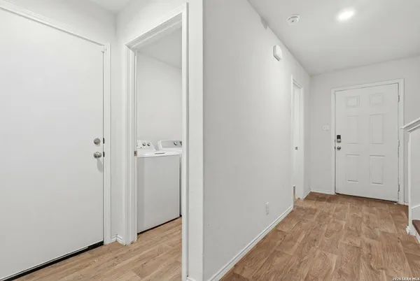 a view of a room with wooden floor