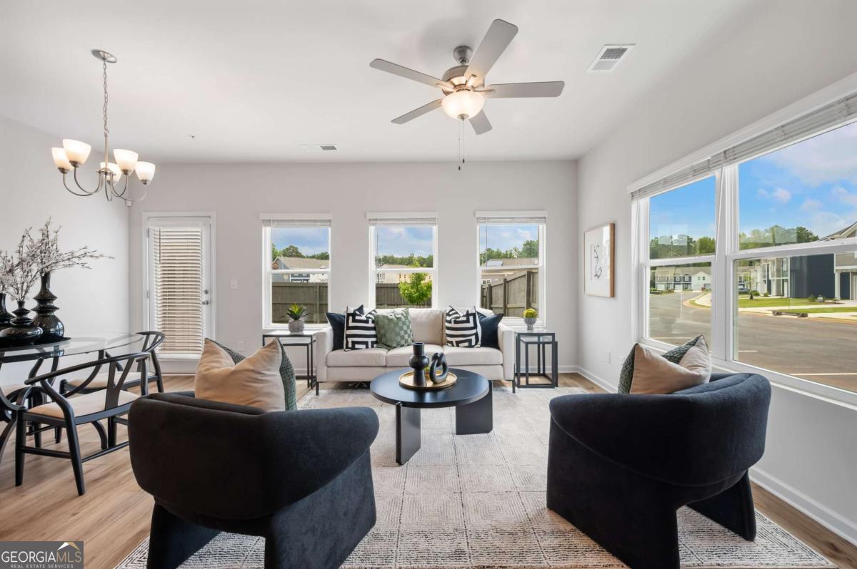9435 Maple Grove Lane Jonesboro, GA 30238 - Photo 13 of 35 a living room with furniture potted plant and a chandelier
