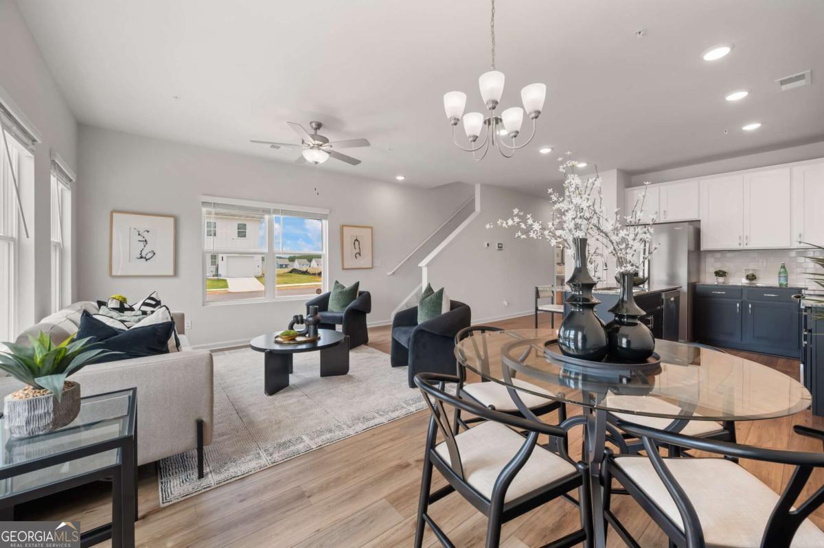 9435 Maple Grove Lane Jonesboro, GA 30238 - Photo 18 of 35 a view of a dining room with furniture a chandelier and wooden floor