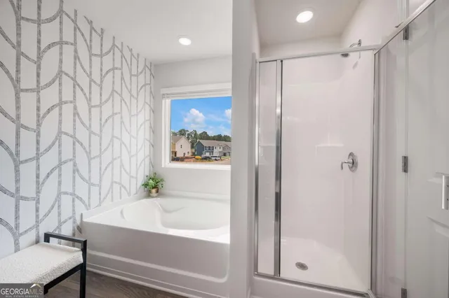 a bathroom with a bathtub and a shower