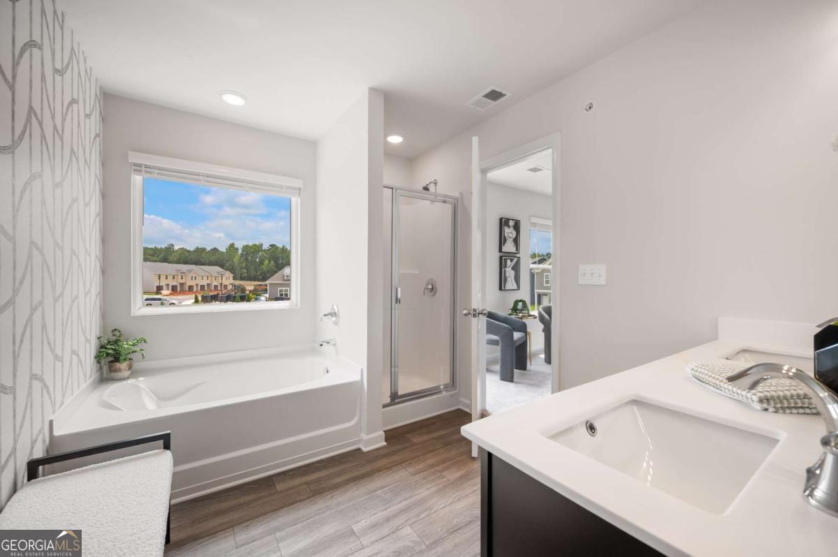 9435 Maple Grove Lane Jonesboro, GA 30238 - Photo 31 of 35 a bathroom with a sink a large mirror and a bathtub