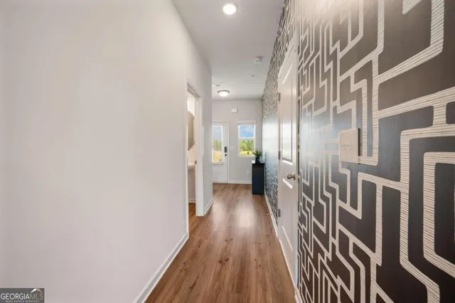 a view of a hallway with wooden floor