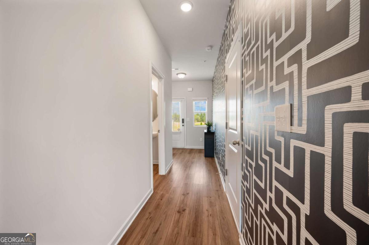 9435 Maple Grove Lane Jonesboro, GA 30238 - Photo 8 of 35 a view of a hallway with wooden floor