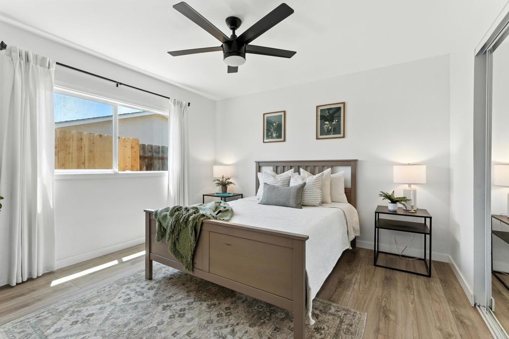 10021 Allenwood Way Santee, CA 92071 - Photo 11 of 28 a bedroom with a bed and a chandelier