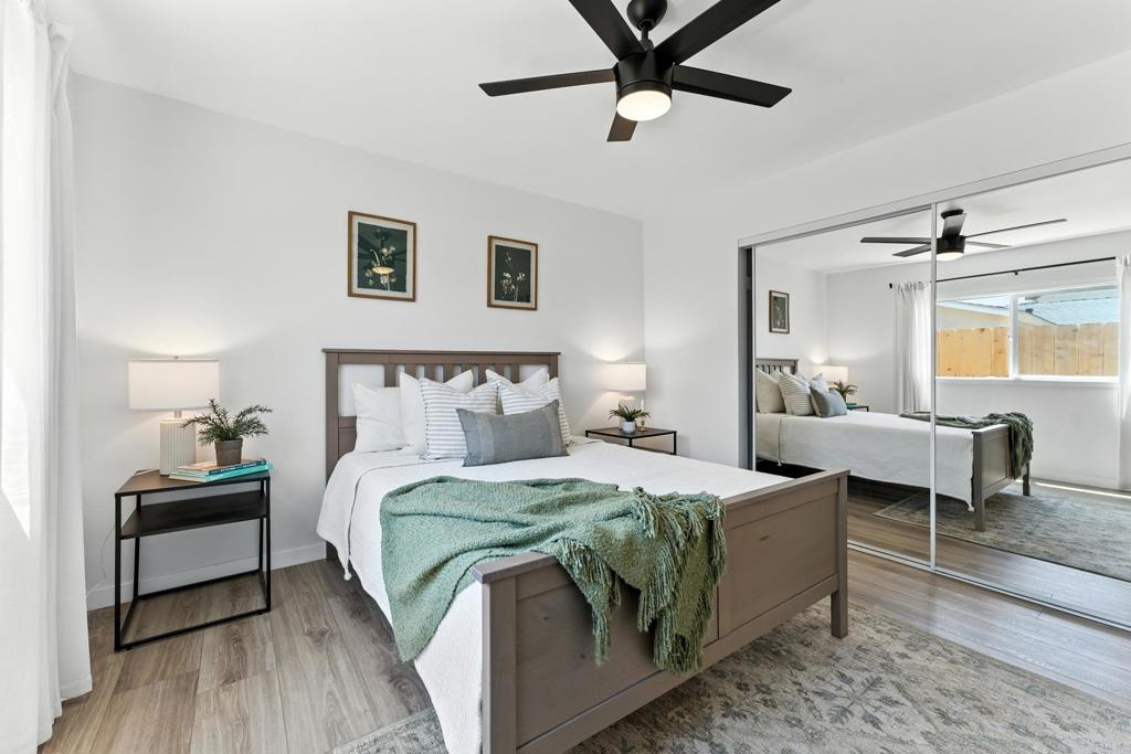 10021 Allenwood Way Santee, CA 92071 - Photo 12 of 28 a bedroom with a bed and a chandelier