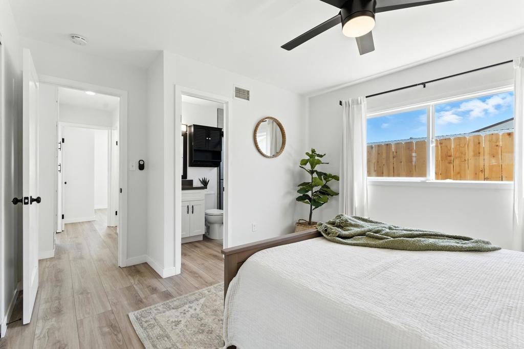 10021 Allenwood Way Santee, CA 92071 - Photo 13 of 28 a bedroom with a bed and a chandelier