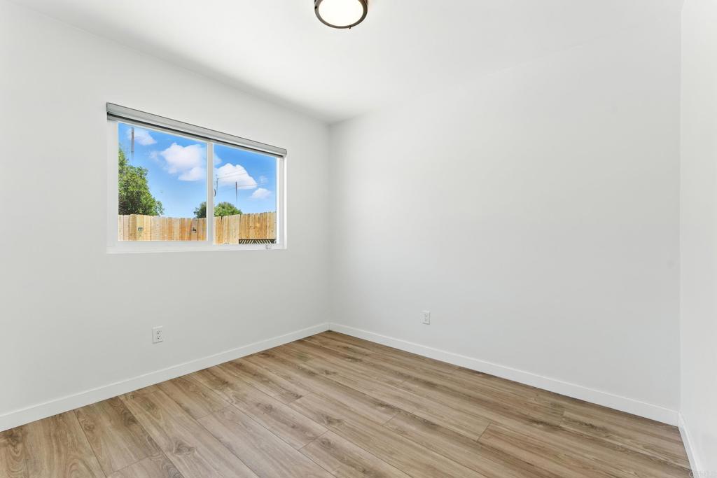 10021 Allenwood Way Santee, CA 92071 - Photo 17 of 28 a view of an empty room with wooden floor and a window